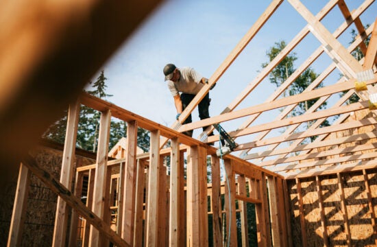 Construction worker putting framing up of a new home.