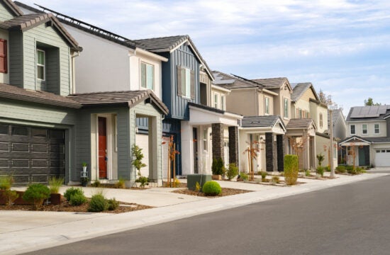 Street of two-story homes in a housing development.